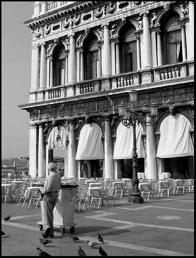 Venetian custodian taking a break in
                Piazza San Marco