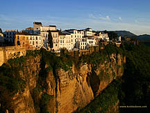 Whitewashed buildings hug the cliffs of the Tajo Gorge in Ronda, Spain